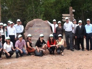 Tourists taking photos at My Son Community-based Tourism Village Photo: VNA